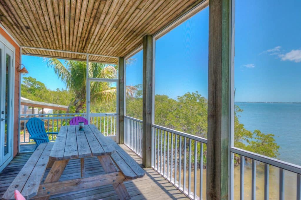 1 Crescent Island - Mansion Screened Deck and Wooden Table, Closer View
